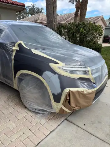 Luxury SUV prepared for paint refinishing